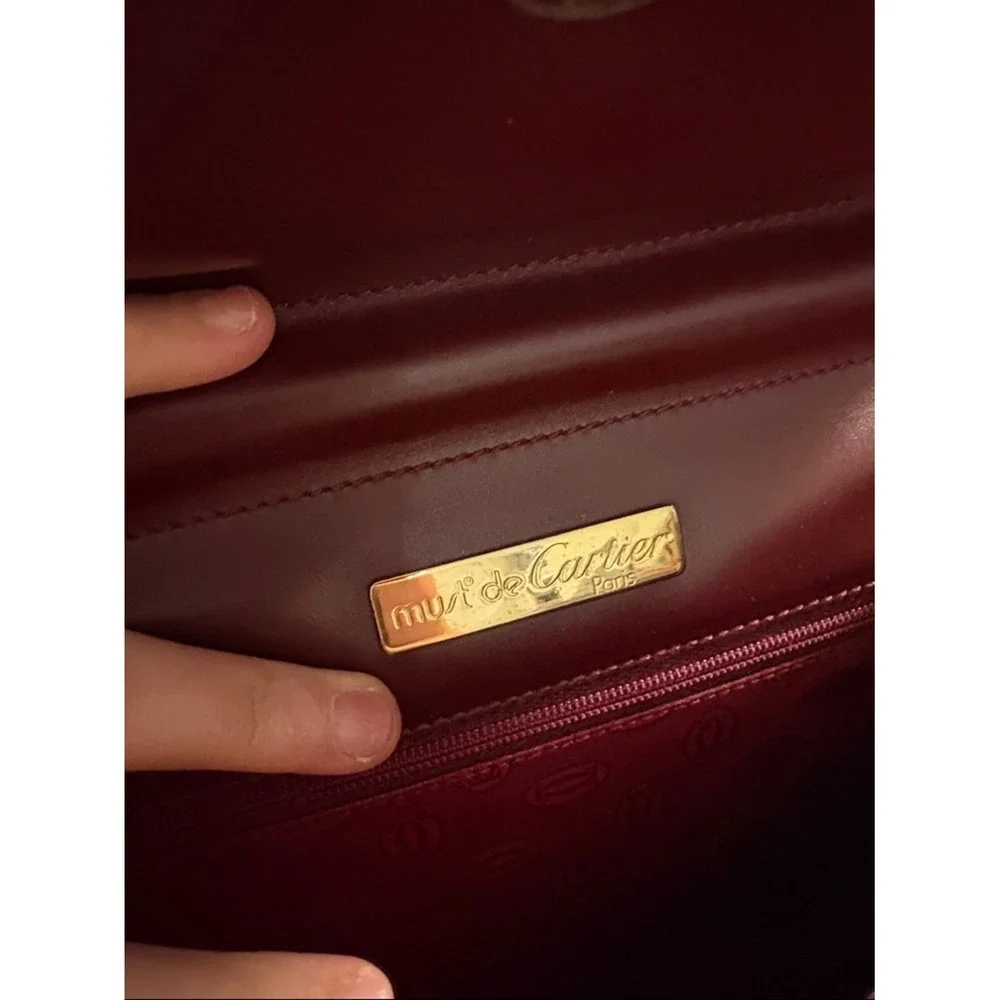 Cartier Burgundy Leather wristlet with Gold Corners